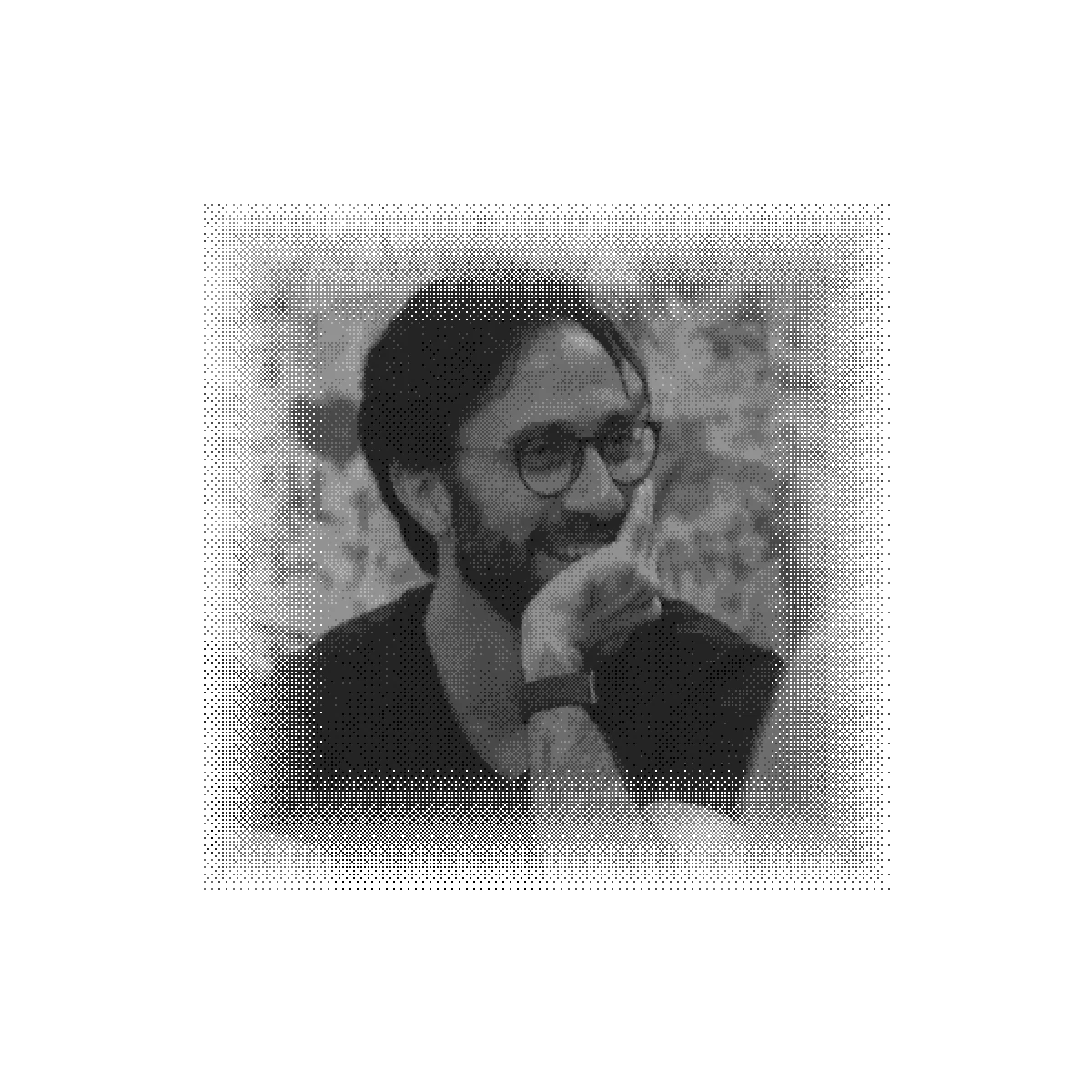 Vikram laughing mid-conversation, rendered as a monochrome halftone print